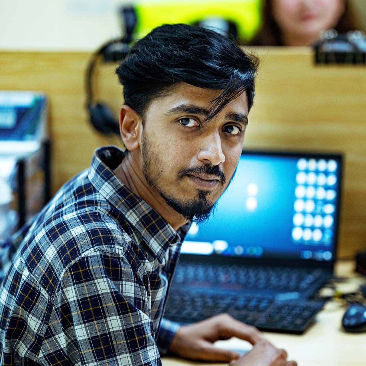 Administrative warehouse employee at laptop in warehouse office